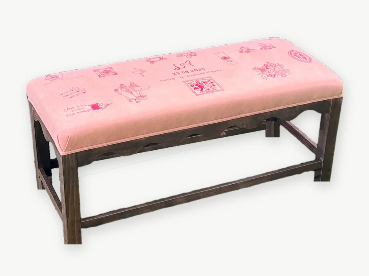 Rosa Bank mit Wellenzarge und roten Stickereien